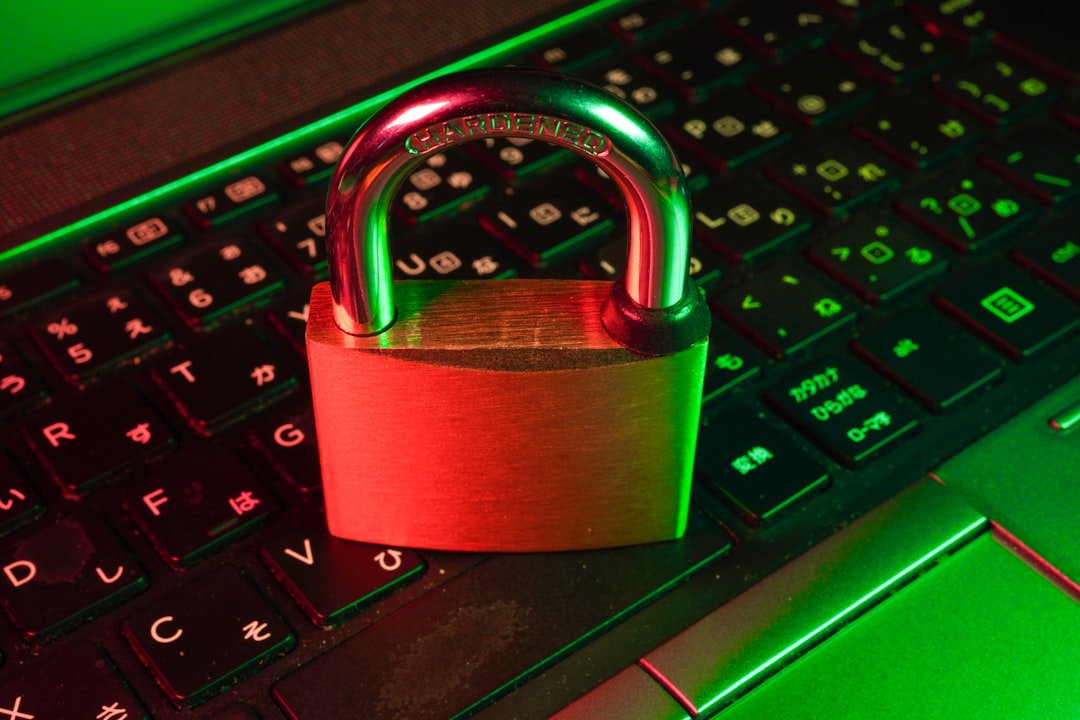 A close-up of a padlock on a laptop keyboard, illuminated with green and red lighting, symbolizing security.
